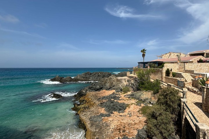 a rocky beach next to a body of water