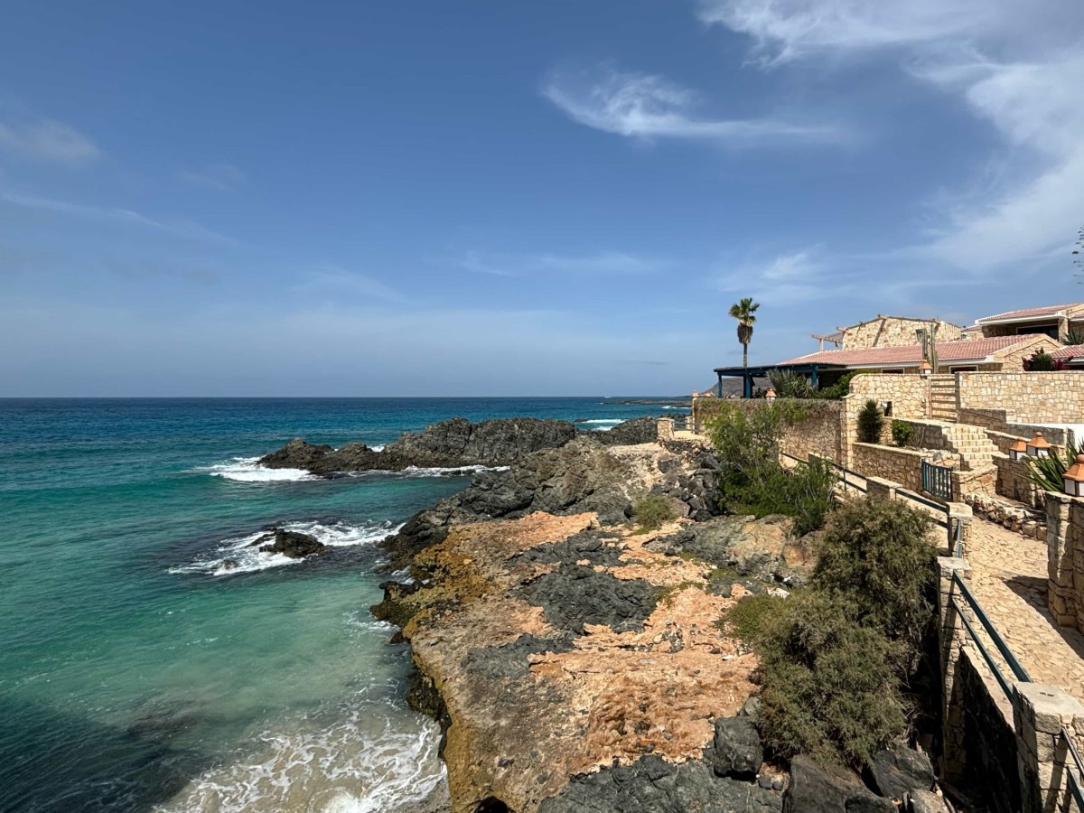 a rocky beach next to a body of water