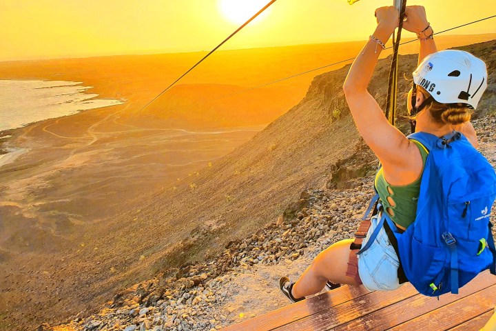 a person standing next to a body of water